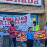 Restaurant worker from Baba Dhaba addressing NSN crowd at protest in July 2022. Banner behind her arguing for ending wage theft / exploitation